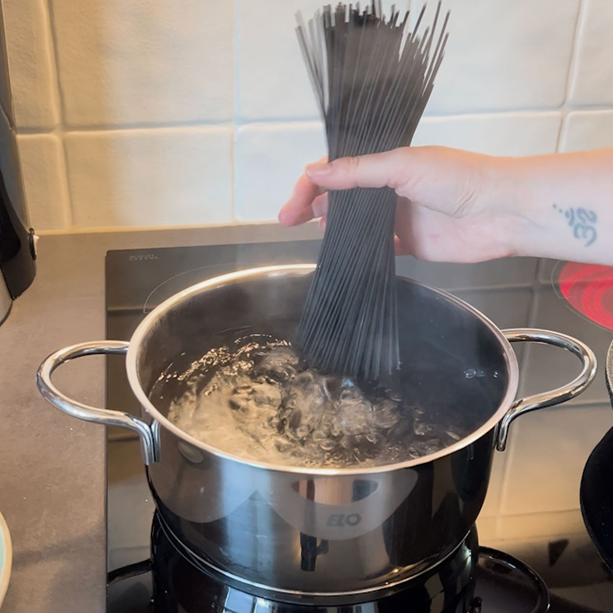 Place black spaghetti into boiling salt water
