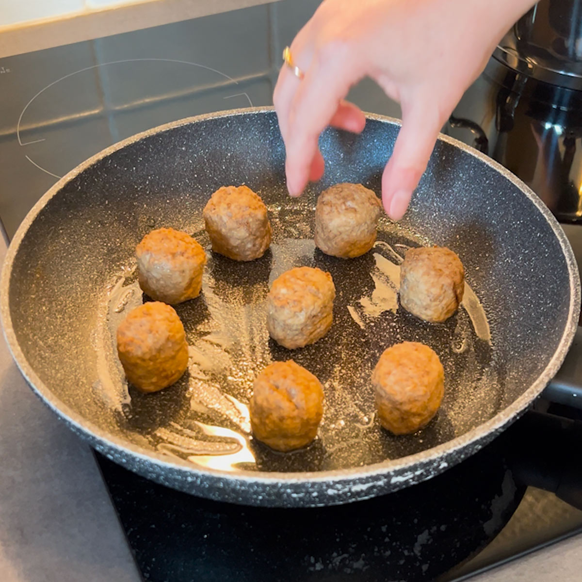 place meatballs into hot skillet with oil