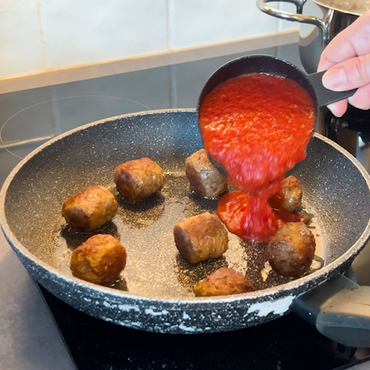 pour crushed tomatoes into the skillet