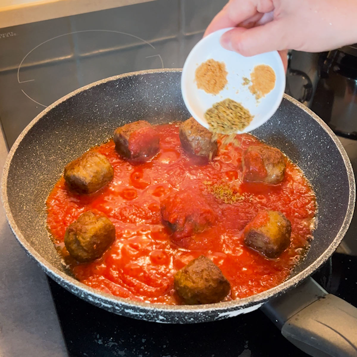 drop seasoning into the tomato sauce
