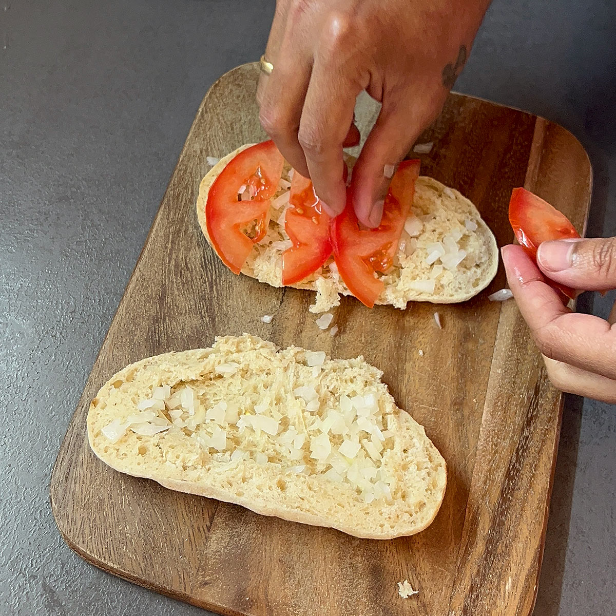 arrange slice tomato over the chopped onion and bottom side of the breads