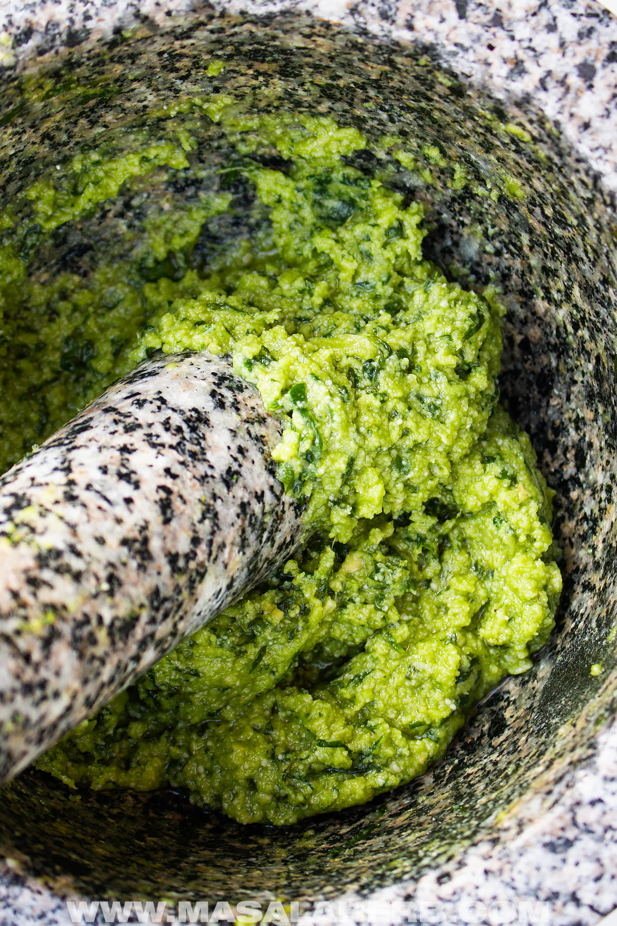 basil pesto with cashews in mortar and pestle