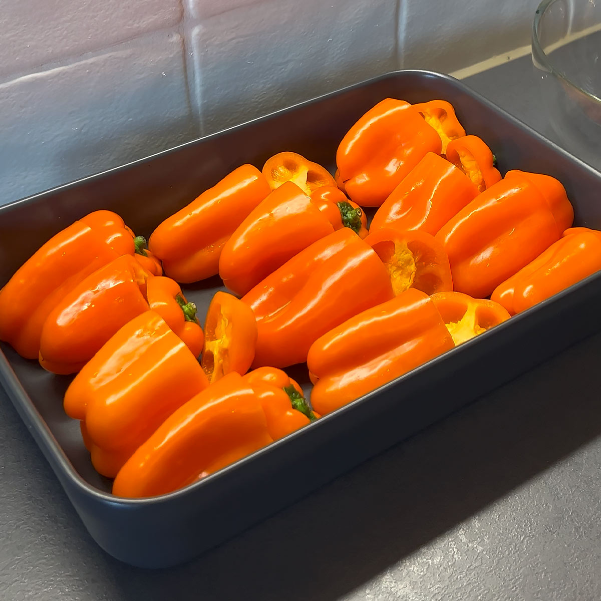 Place peppers into baking dish