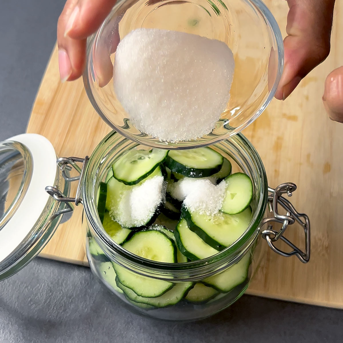 add salt and sugar to the cucumber in the jar