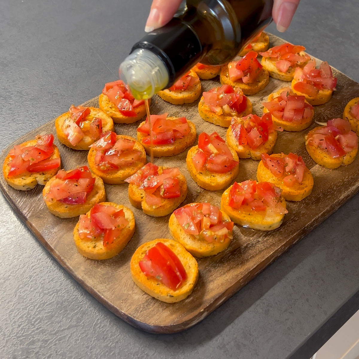 drizzle olive oil over tomato bruschetta