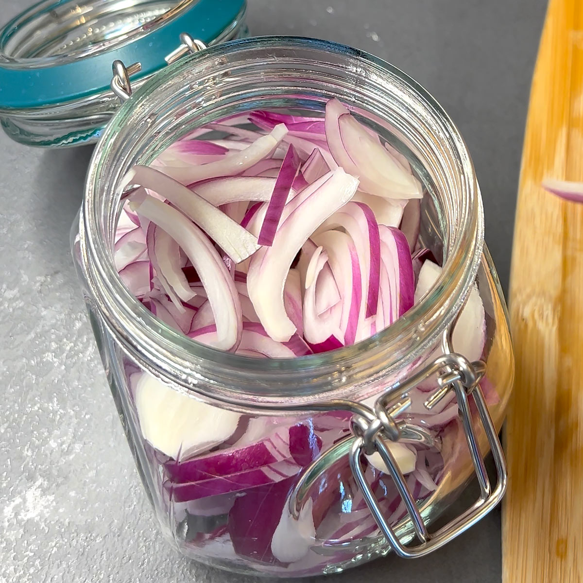 pack sliced red onions into canning jar