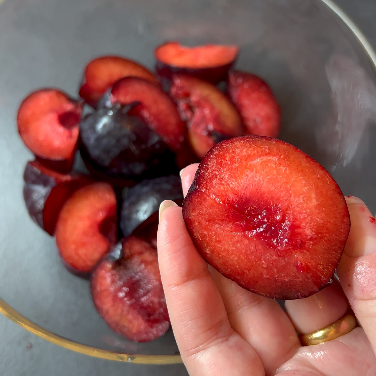 cut plums into quarter or halves