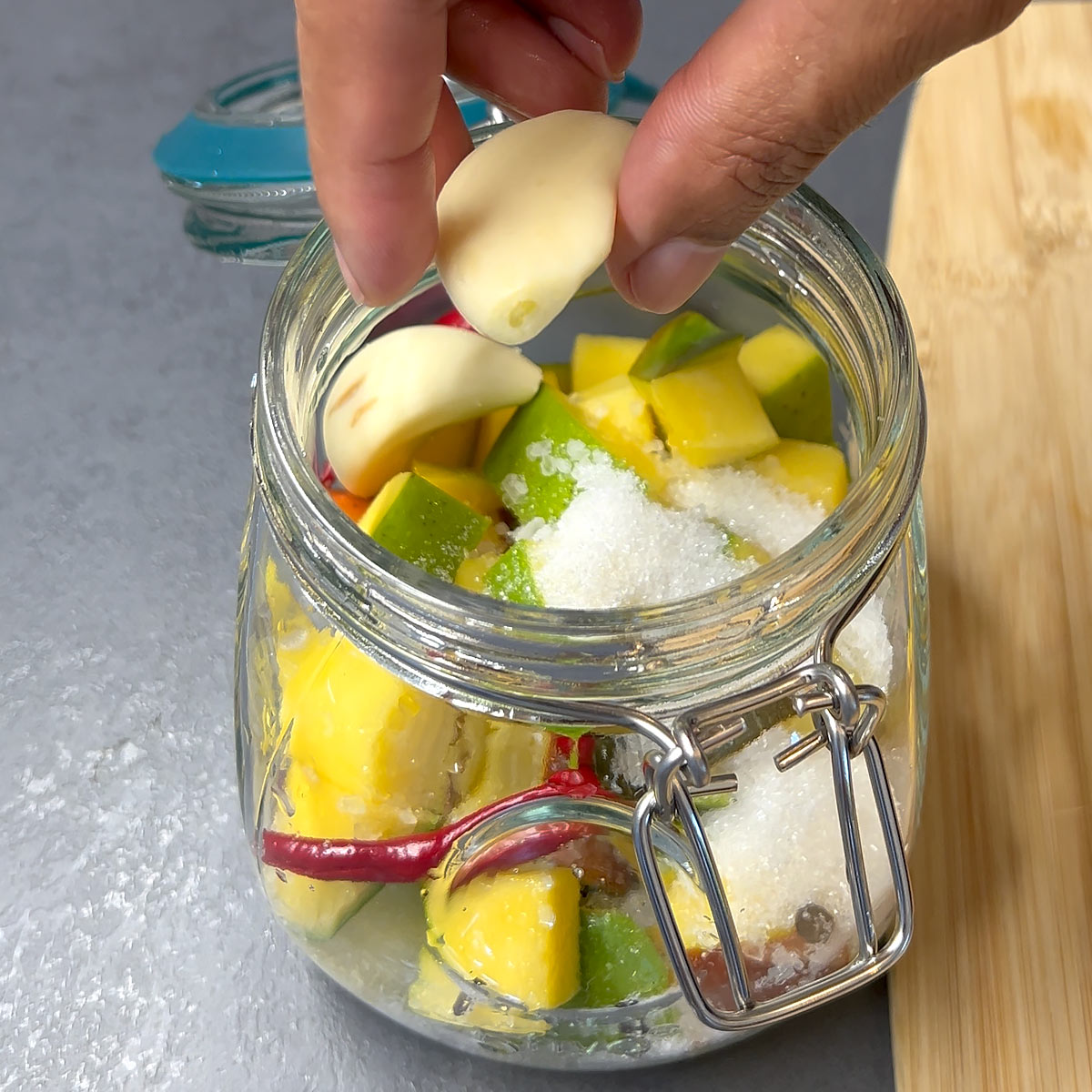 add garlic, sugar, salt to. mango
