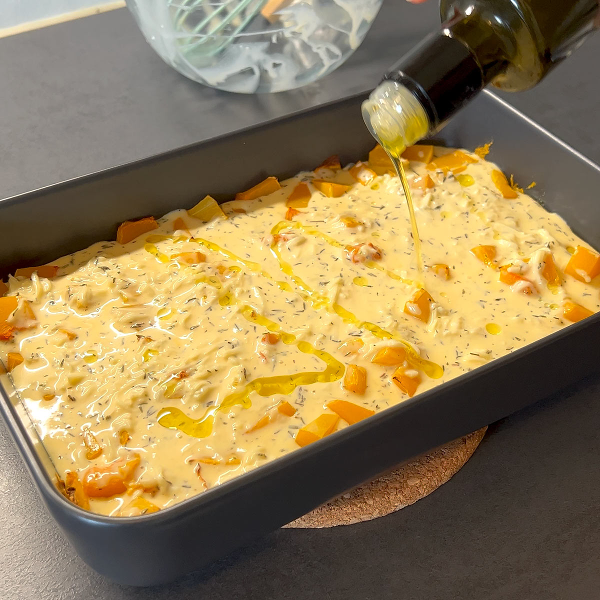 drizzle oil over the uncooked casserole dish