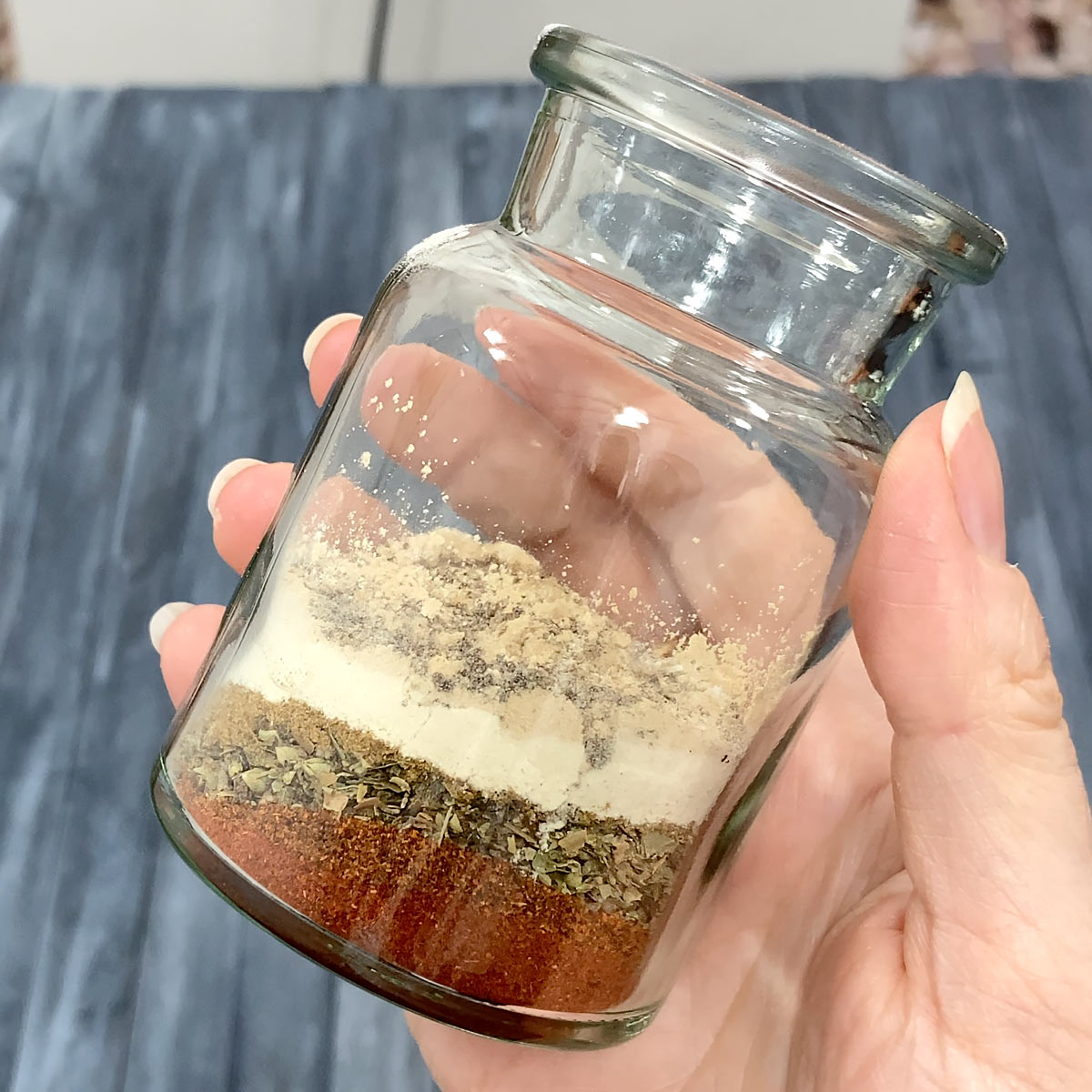 spices for chili seasoning layered in a bottle