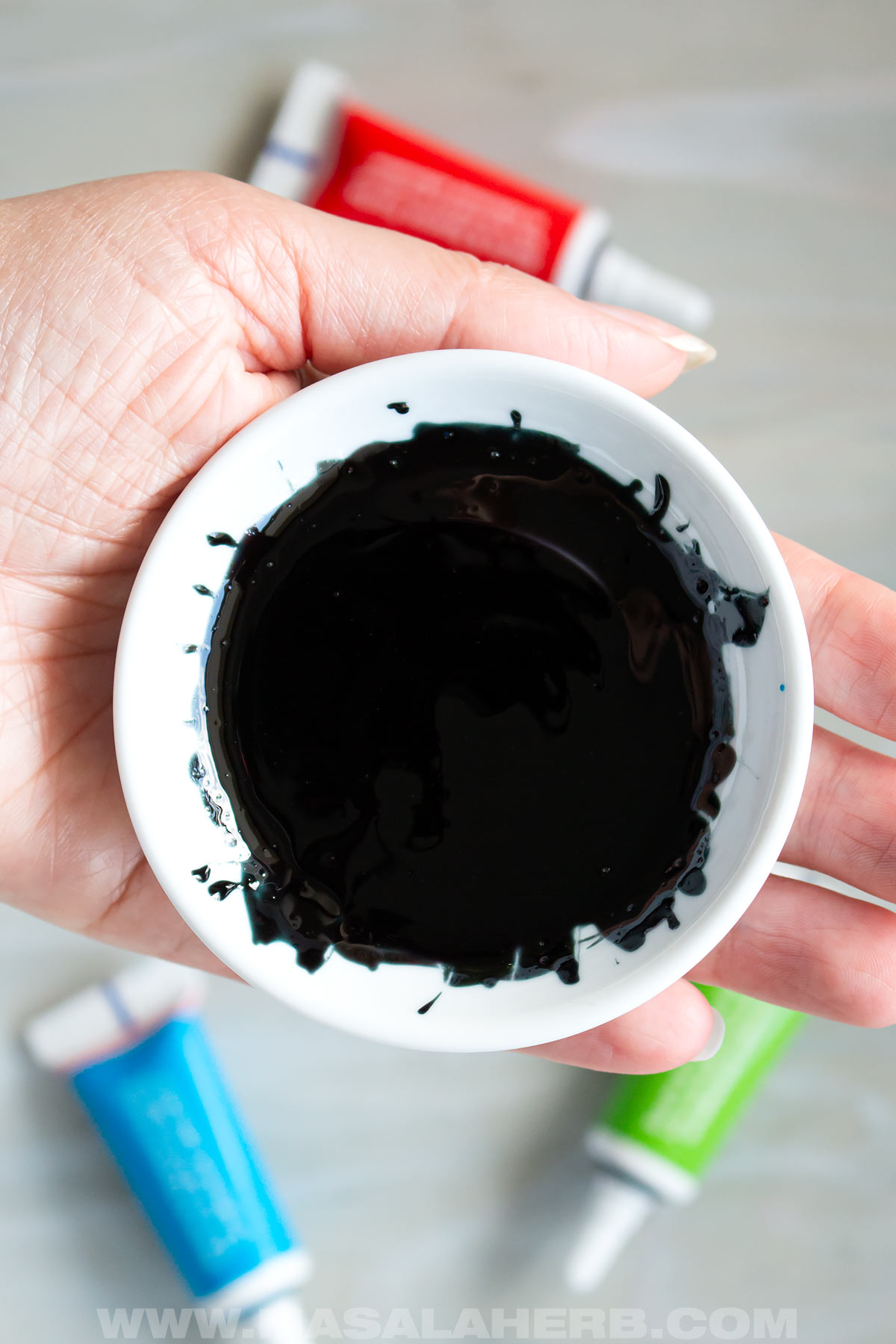 mixing black food coloring