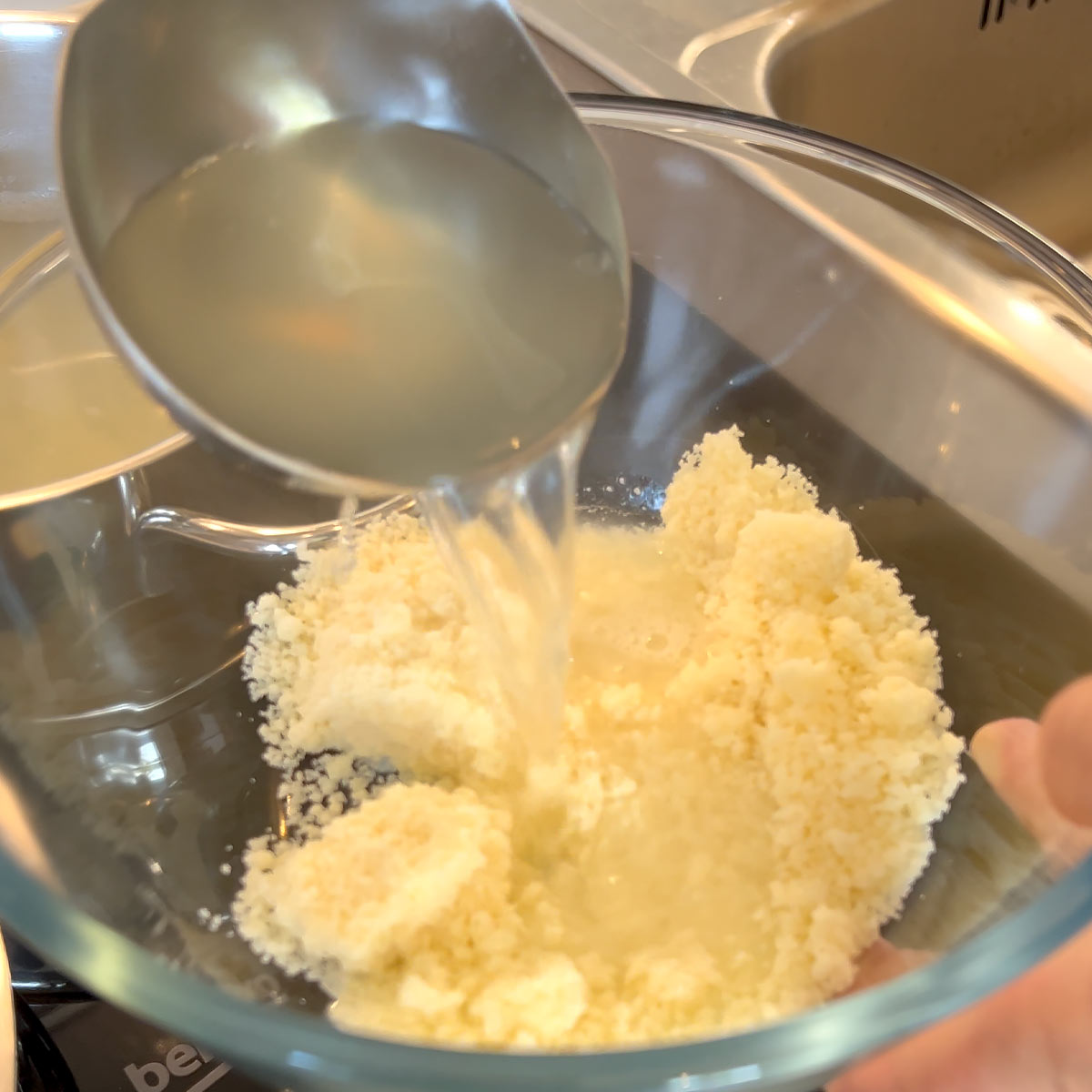 pour pasta water to the parmesan