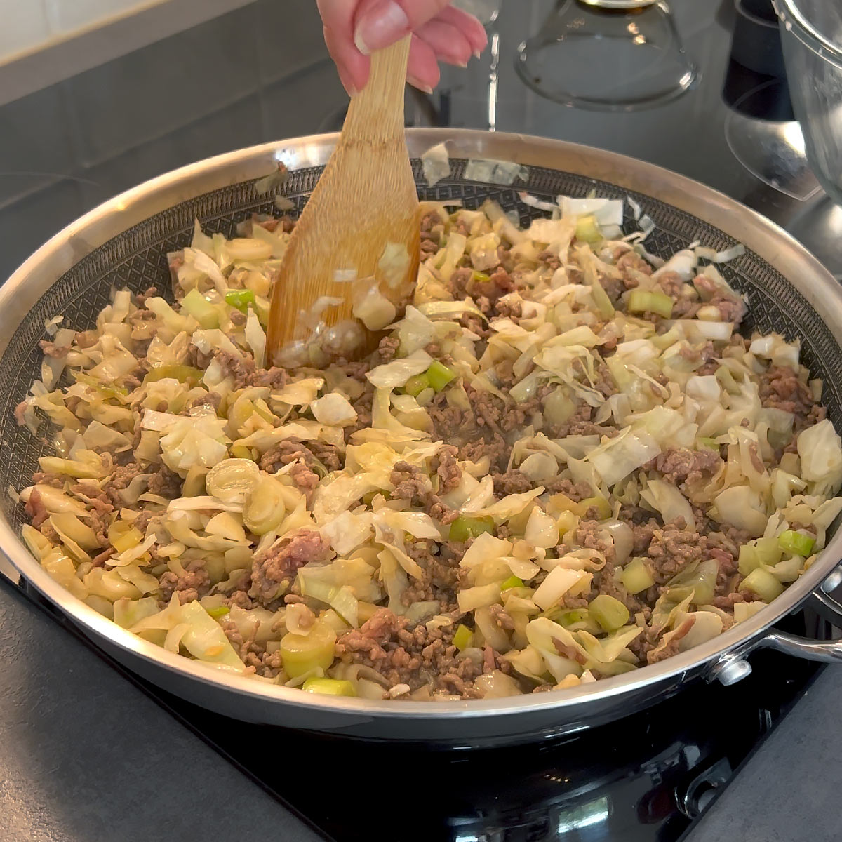 Stir cook cabbage and ground beef in the skillet