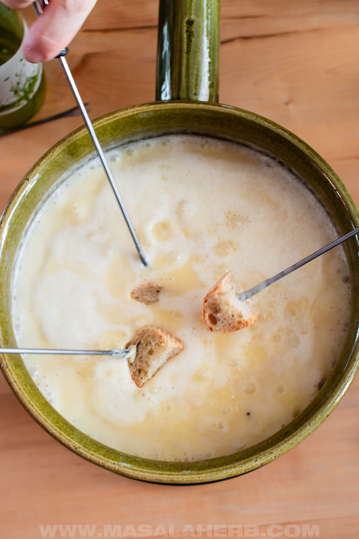 dipping bread in cheese fondue