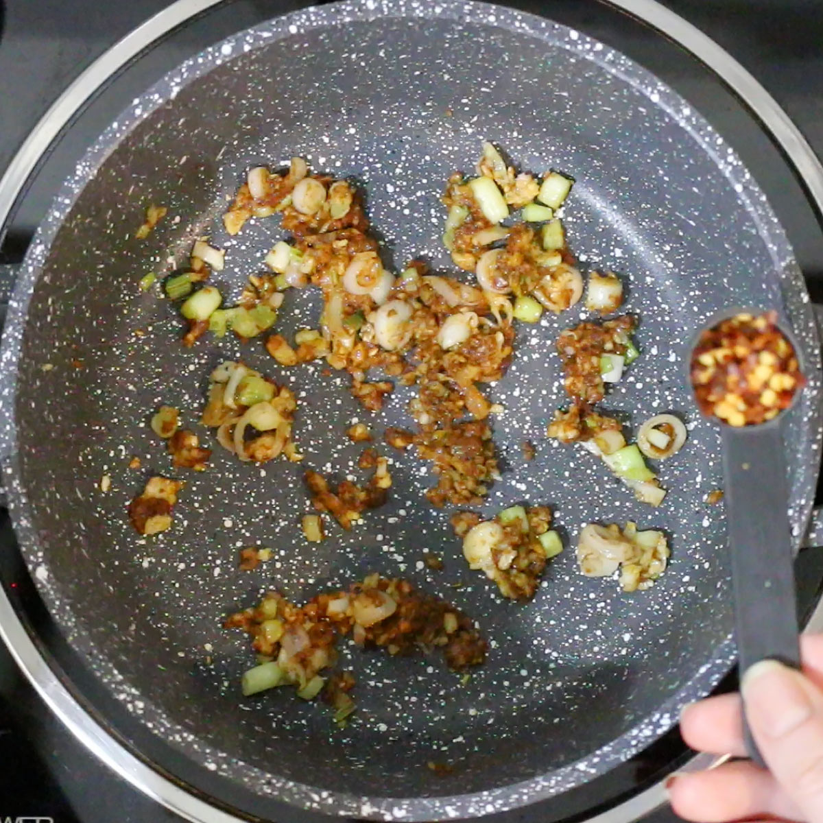 stir in thai red chili paste and red chili flakes