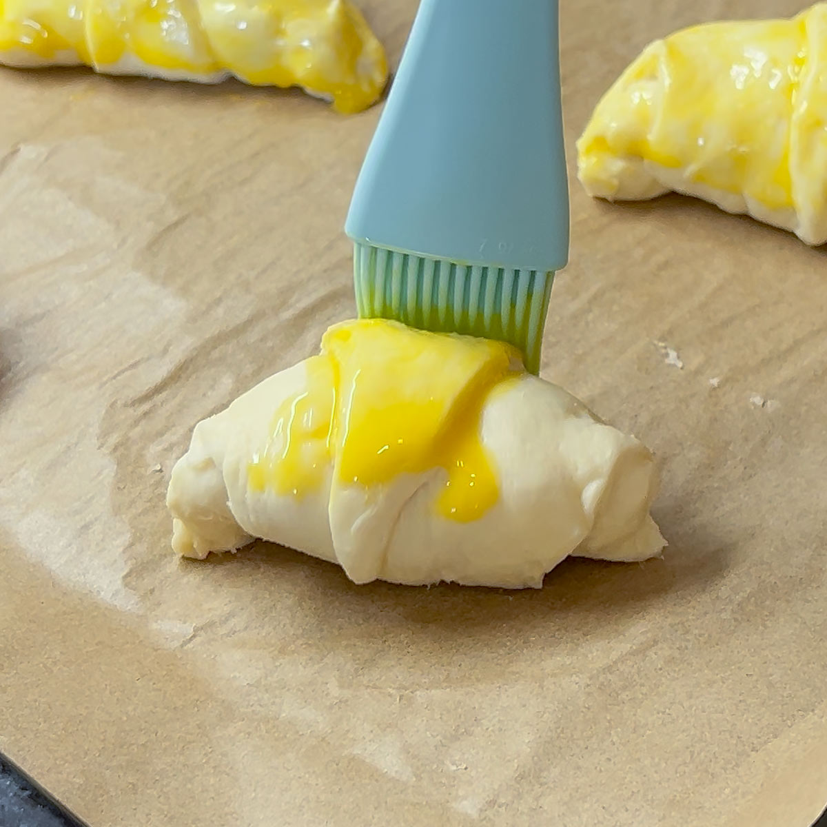 brush yolk over croissant